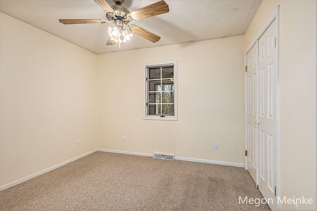 unfurnished room with carpet and ceiling fan