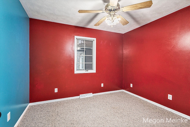 carpeted spare room featuring a textured ceiling and ceiling fan