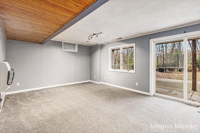 carpeted spare room with wooden ceiling