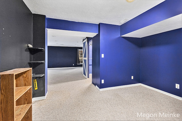 interior space with a textured ceiling and carpet floors