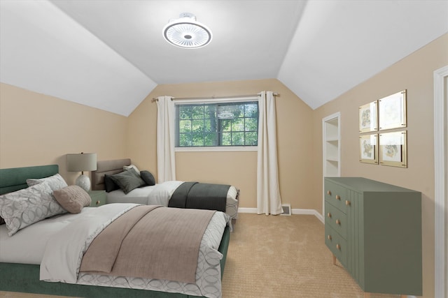 bedroom featuring light colored carpet and lofted ceiling