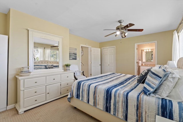 carpeted bedroom featuring connected bathroom and ceiling fan