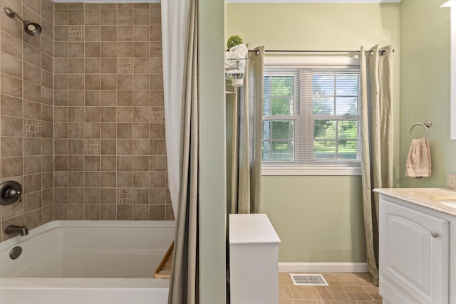 bathroom with tile patterned floors, vanity, and shower / bath combo with shower curtain