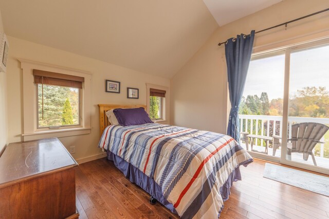 bedroom with access to exterior, lofted ceiling, and dark hardwood / wood-style flooring