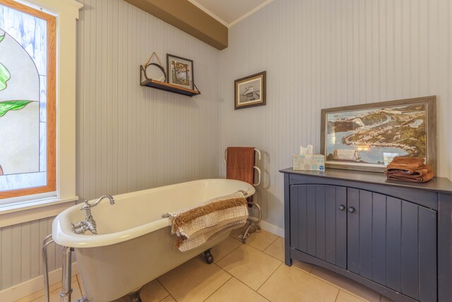 bathroom with crown molding, radiator heating unit, a tub to relax in, and tile patterned floors