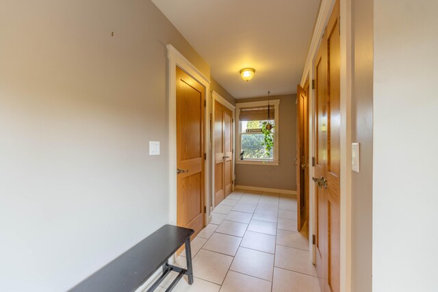 hall featuring light tile patterned floors