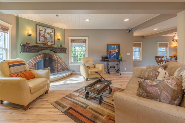 living room with wood ceiling, light hardwood / wood-style flooring, a fireplace, and crown molding