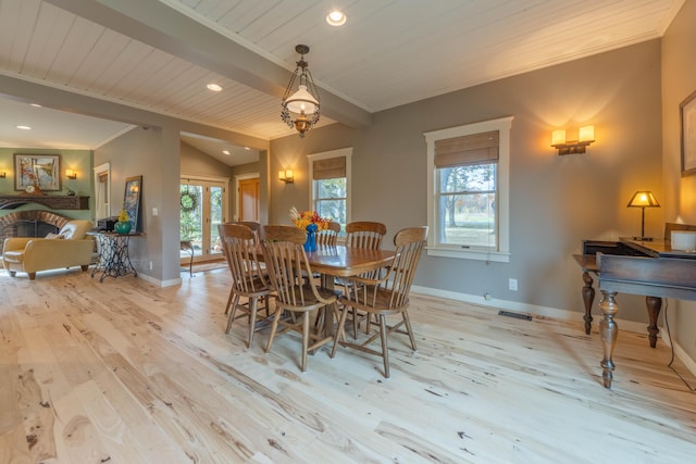 dining space with a brick fireplace, wood ceiling, vaulted ceiling with beams, ornamental molding, and light hardwood / wood-style floors