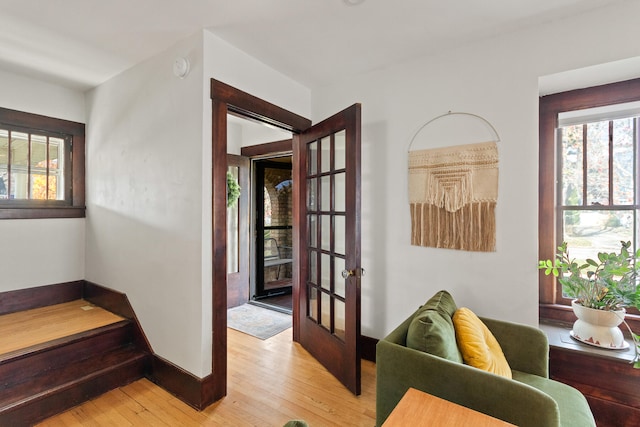 interior space with french doors and light hardwood / wood-style floors