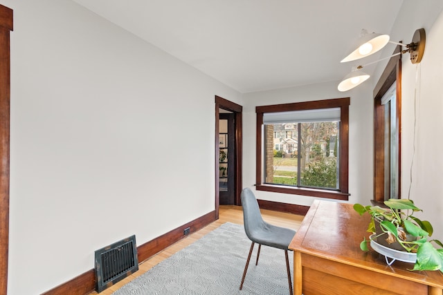 office space with light hardwood / wood-style flooring