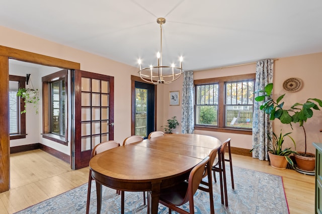 dining room with a chandelier and light hardwood / wood-style flooring