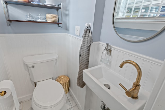 bathroom with tile patterned flooring, toilet, and sink