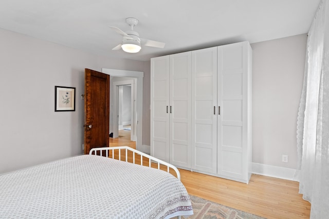 bedroom with ceiling fan, light wood-type flooring, and a closet