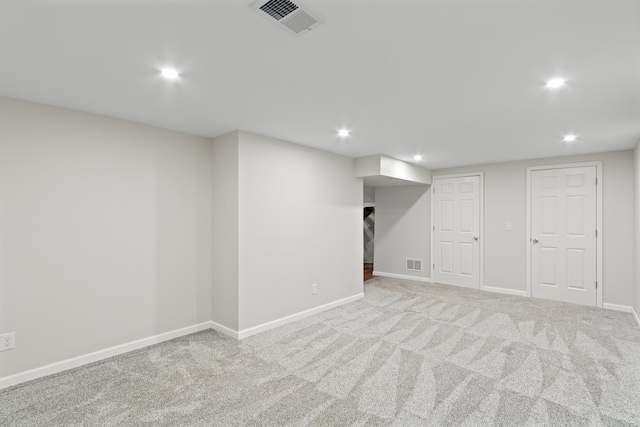 basement featuring light colored carpet