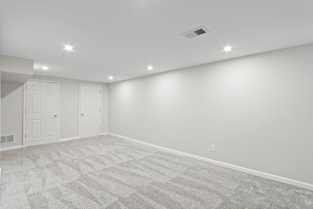 basement featuring light carpet