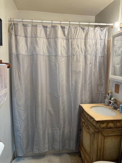 bathroom with vanity and a shower with shower curtain