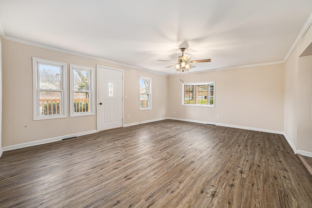 foyer entrance featuring dark wood-type flooring, a healthy amount of sunlight, and crown molding