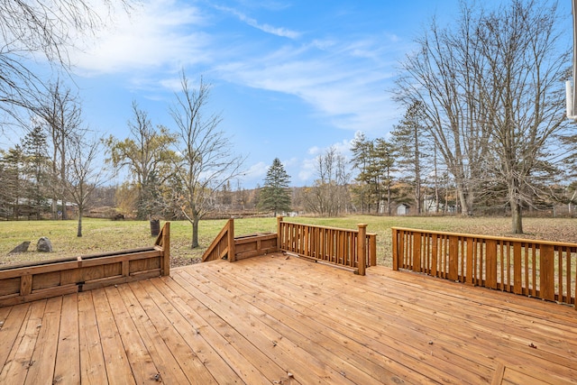 wooden terrace featuring a yard