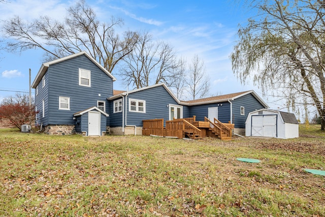 back of property featuring a lawn, a storage unit, and a wooden deck