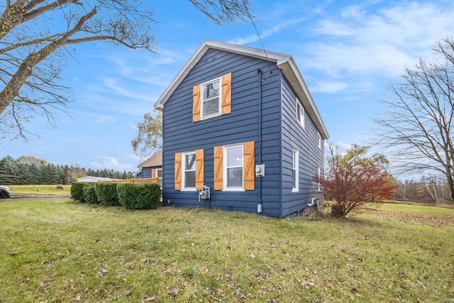 view of property exterior featuring a lawn