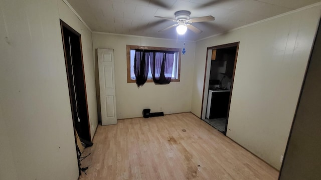 interior space with light hardwood / wood-style flooring, ceiling fan, and ornamental molding