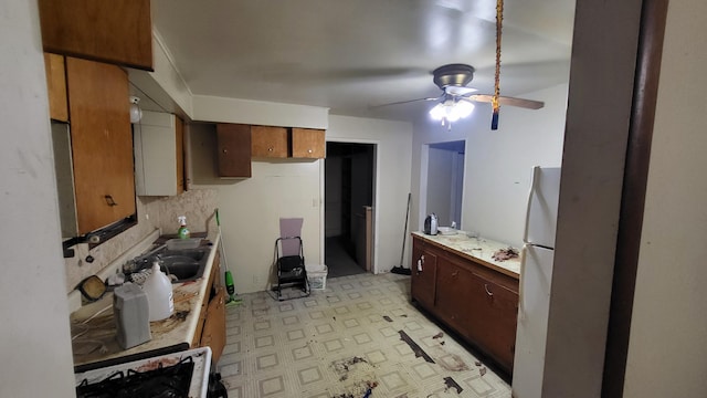 kitchen featuring ceiling fan, white appliances, and sink