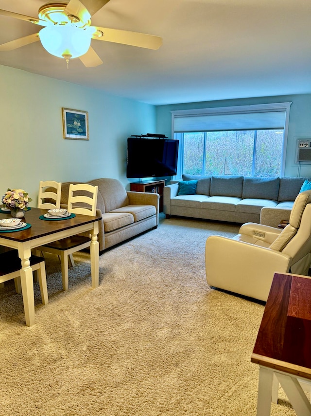 carpeted living room with an AC wall unit and ceiling fan