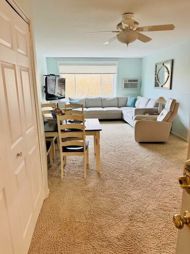 living room with carpet flooring, ceiling fan, and a wall unit AC