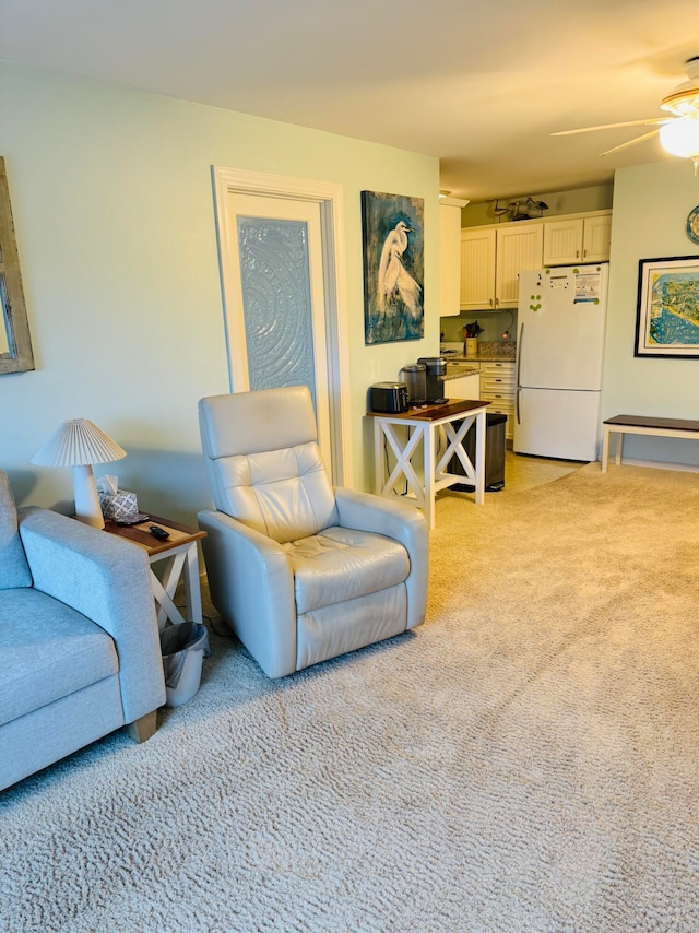 carpeted living room featuring ceiling fan