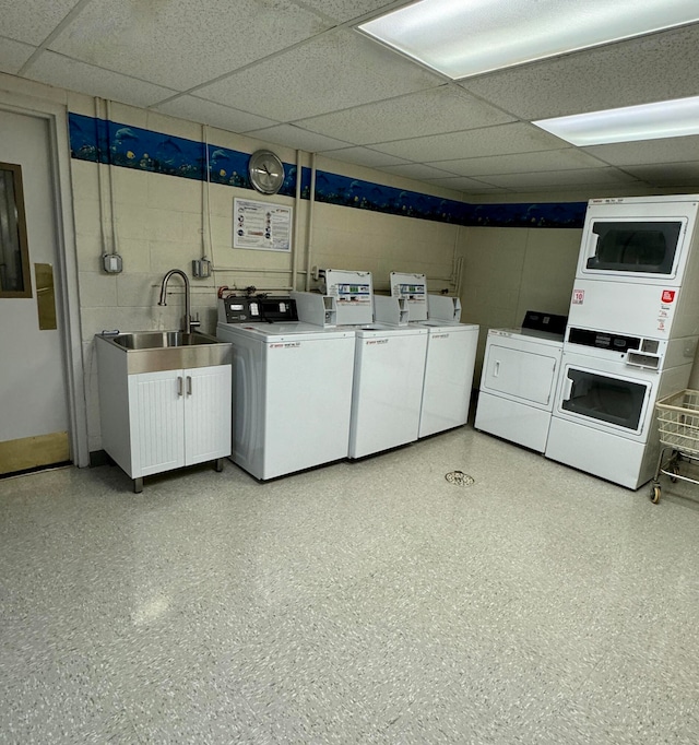 clothes washing area with washer and clothes dryer and sink