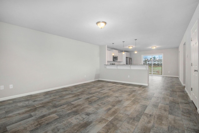 unfurnished living room with dark hardwood / wood-style flooring