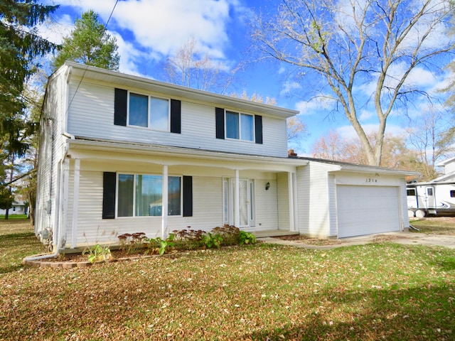 front of property with a garage and a front lawn