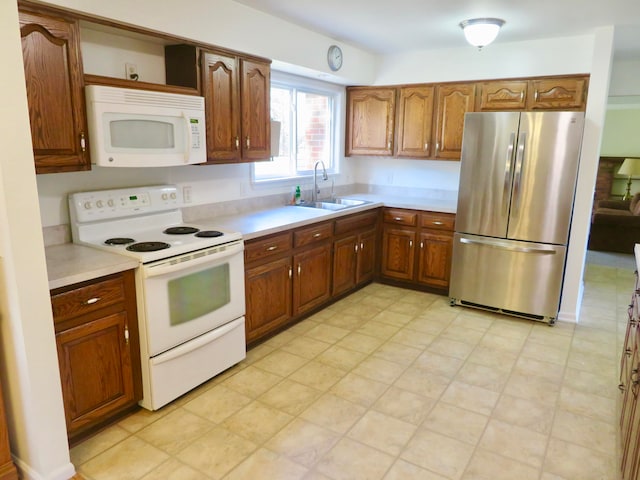 kitchen featuring white appliances and sink