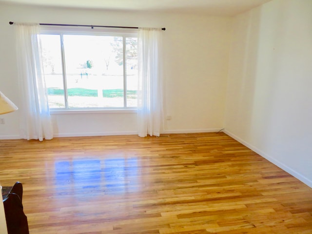 unfurnished room with light hardwood / wood-style flooring