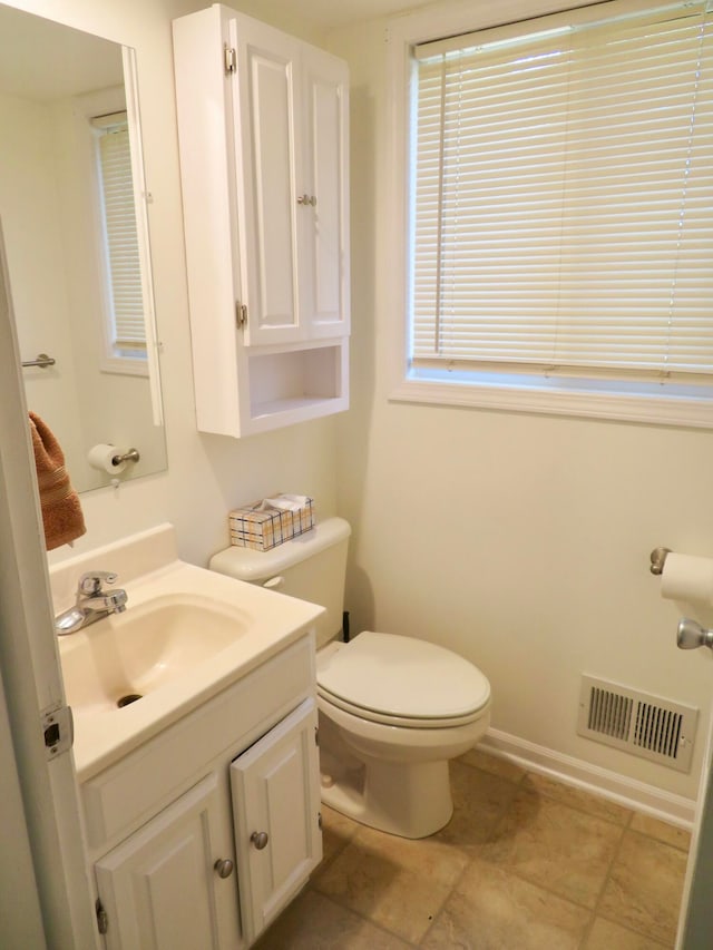 bathroom featuring toilet, vanity, and tile patterned flooring