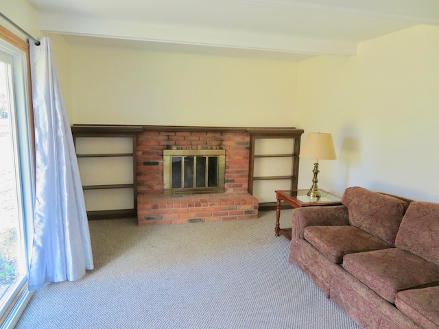 living room with a fireplace, a healthy amount of sunlight, and carpet floors