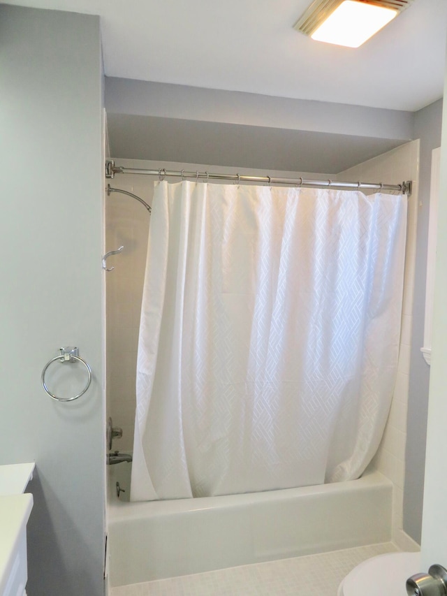 bathroom featuring vanity and shower / tub combo with curtain