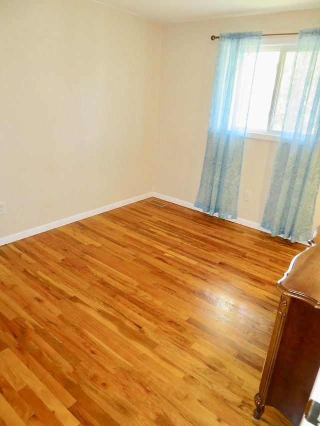 empty room with light hardwood / wood-style floors