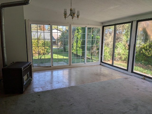 unfurnished sunroom featuring an inviting chandelier and vaulted ceiling