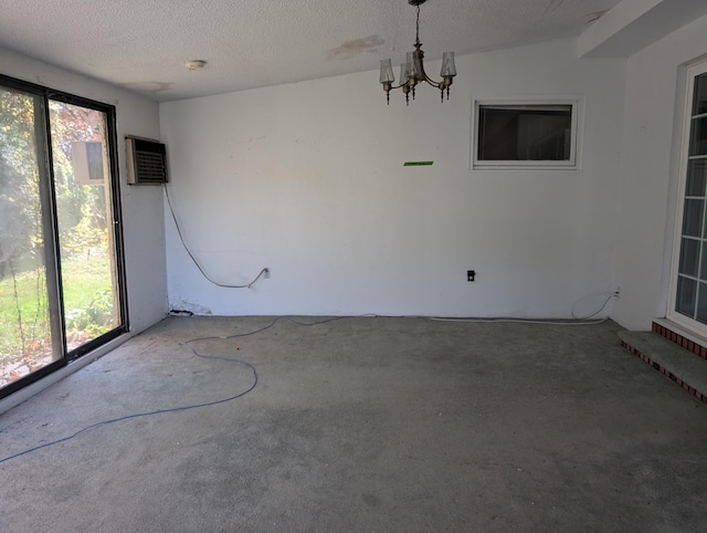 unfurnished room with carpet floors, a wealth of natural light, lofted ceiling, and a textured ceiling