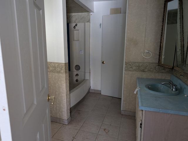 bathroom featuring tile patterned flooring, vanity, and tile walls