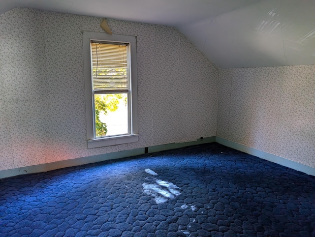 bonus room featuring lofted ceiling and carpet