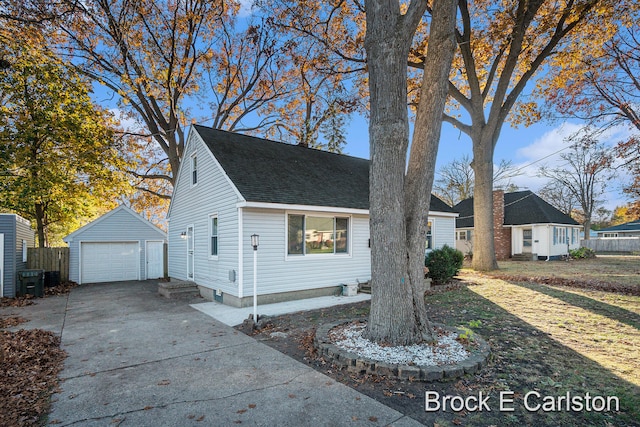 view of front facade featuring a front lawn, a garage, and an outdoor structure