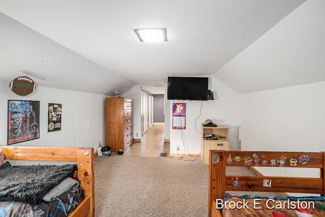 bedroom featuring lofted ceiling and light carpet