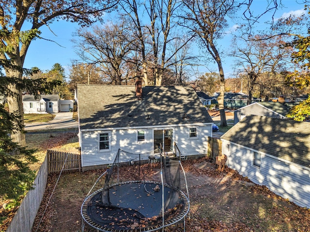 back of house featuring a trampoline