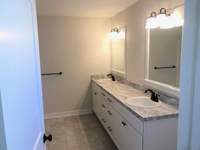 bathroom featuring tile patterned flooring and vanity