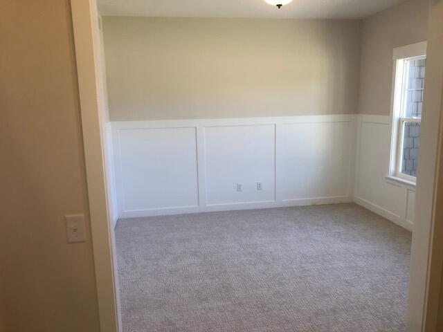 carpeted spare room featuring plenty of natural light