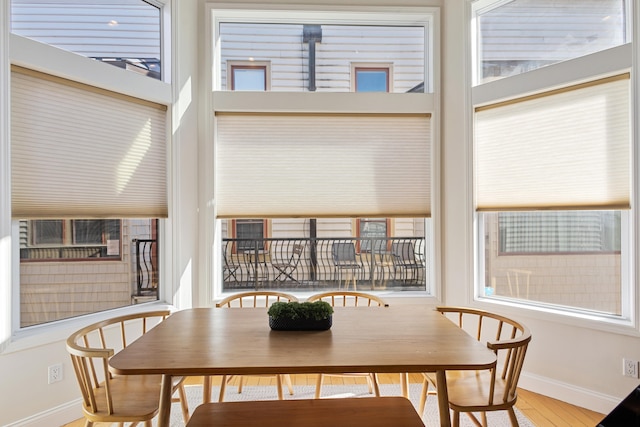 dining space with wood-type flooring