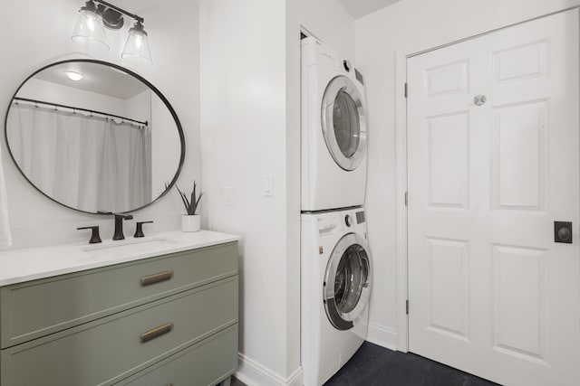 laundry room with stacked washing maching and dryer and sink