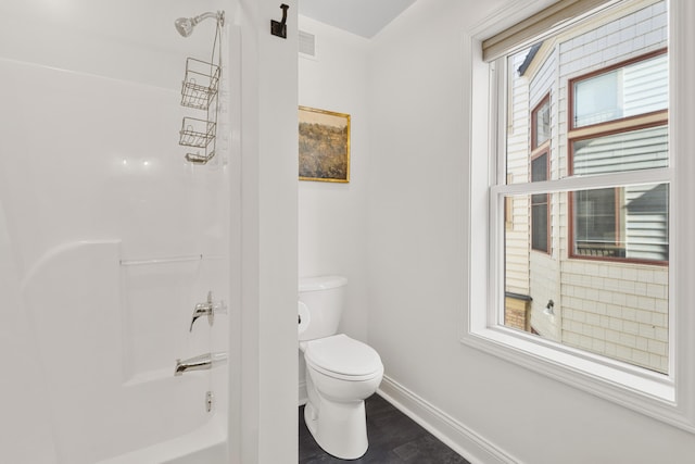 bathroom with shower / washtub combination and toilet